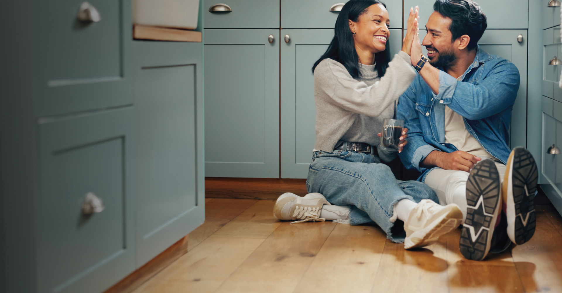 Family playing games in a living room with a hardwood floor